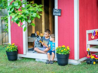 Kids and Dog Sitting in Doorway of Shed