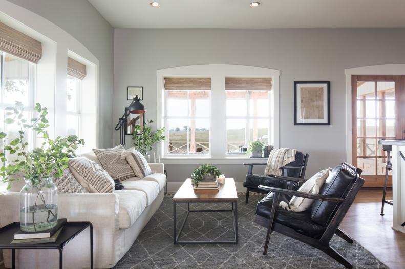 Neutral Living Room w Large White Windows, Gray Rug and Brown Floors