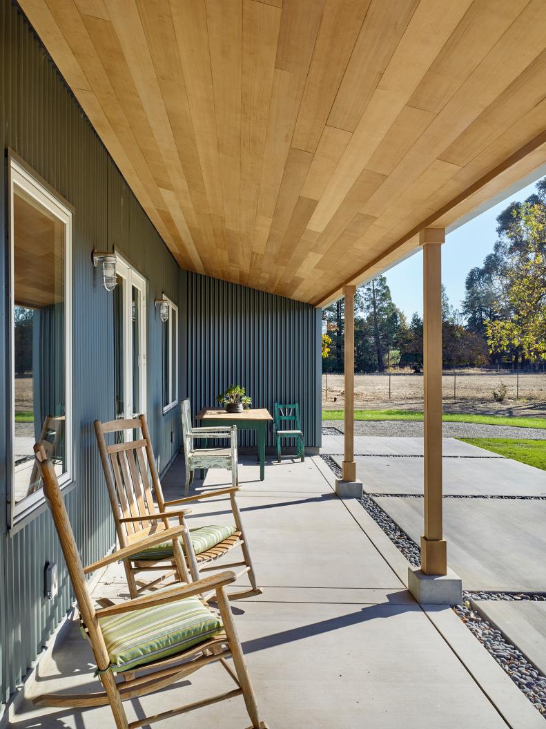 A welcoming covered porch with warm cedar and corrugated siding. 