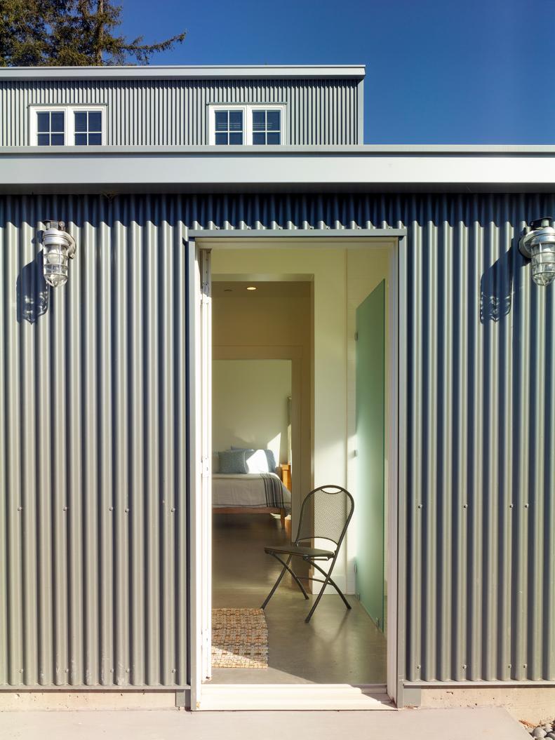 A home exterior with industrial lights and view of the bedroom. 