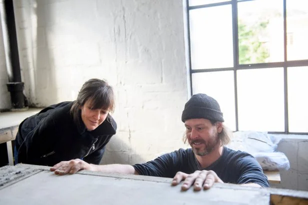 As seen on Restored by the Fords, Steve Ford works on the poured-cement kitchen countertop during renovations to his personal home in Pittsburgh, PA. Leanne and Steve Ford are renovating the industrial building into an apartment.