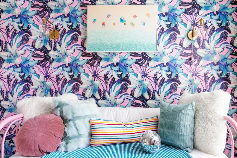 Pink Daybed With Textured Pillows In Front of Tropical Wallpaper