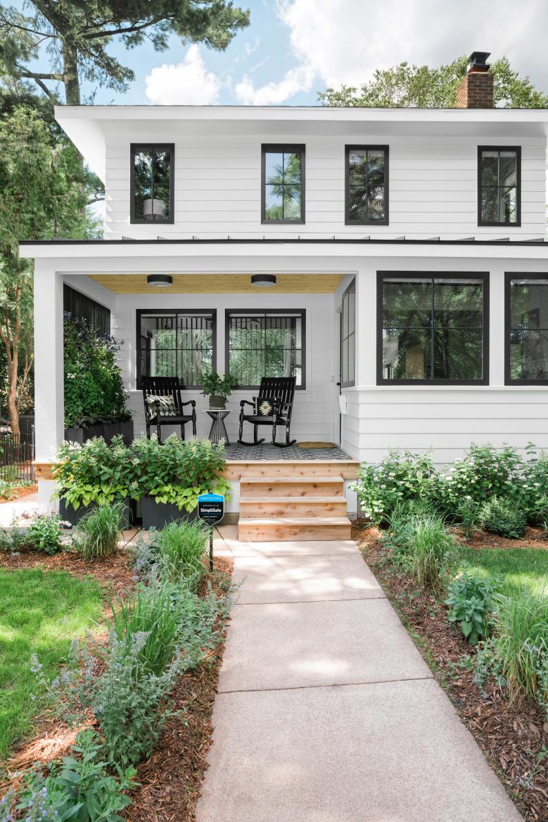 Walkway Lined With Grasses Leads to White Foursquare House