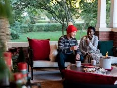 A Couple Makes S'mores On a Front Porch