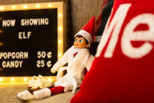 Elf on the Shelf ® is a game played at Christmastime where a Scout Elf visits from the North Pole to see who made Santa's nice list. Each night, after kids are in bed, parents move the elf into different poses. Setting up a movie night with your Elf on the Shelf ® is a great way to entertain your kids for an evening.