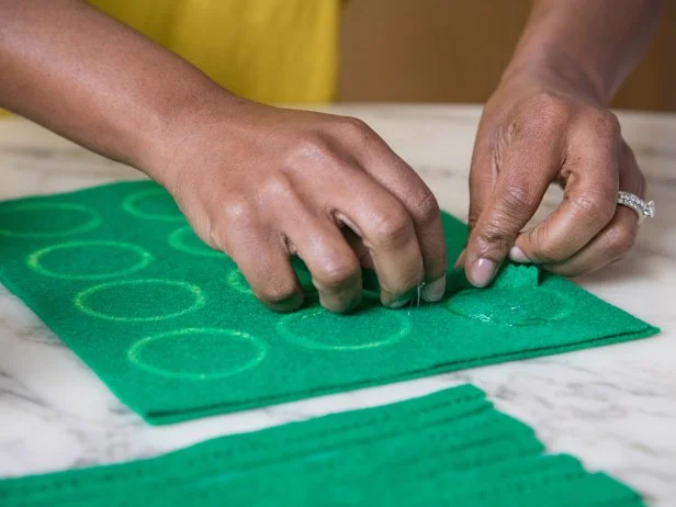 Hot glue is a quick and effective way to attach felt to felt.