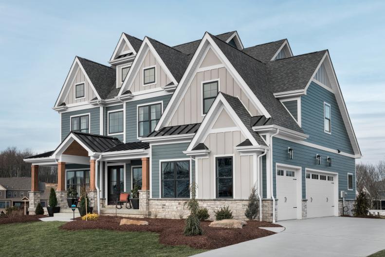 Three-Story Blue-and-White Craftsman Home With Black Roof