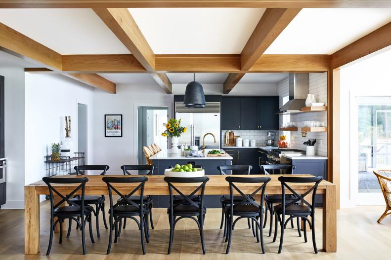 Bright Space Features a Large Dining Table and Exposed Wood Beams