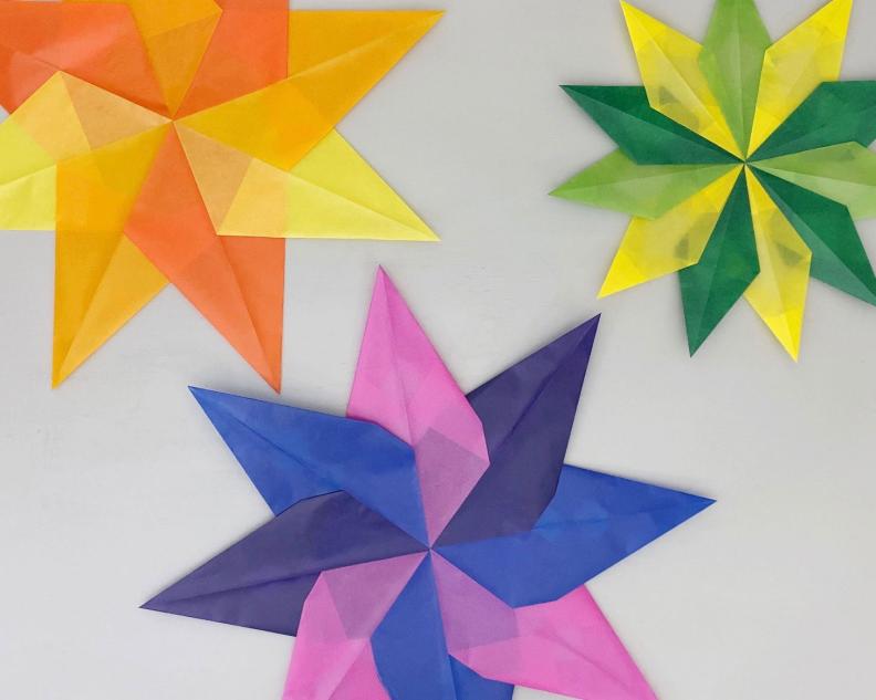 A  Yellow Star, A Green Star and A Purple Star Made From Kite Paper 