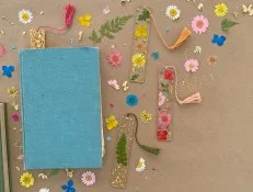 Resin Bookmarks With Dried Flowers Inside Placed In Books on Table