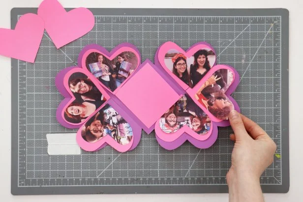 Cut another ⅛” off from the heart pattern. Print out six photos that are the same size as this smaller heart. Trace the heart onto each photo and cut them out.