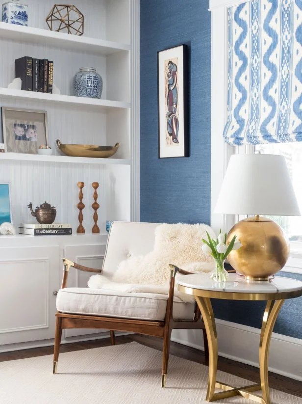 “The walnut wood, square upholstery, light button tufts and simple lines of this chair from Anthropologie are typical of midcentury design, while the shiny brass caps bring the chair into this century," says Kerri Pilchik, Owner of Kerri Pilchik Design in Ridgewood, New Jersey.