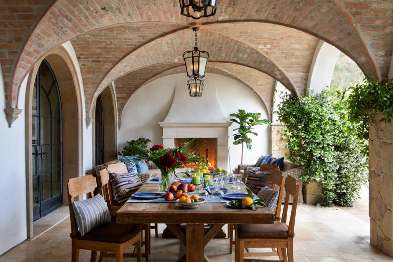 Covered patio with brick vaulted ceilings and cozy outdoor fireplace. 