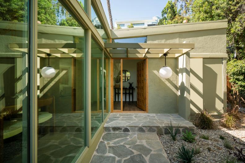 This midcentury modern home features a flagstone entrance.
