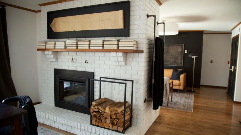 Books Turned Pages-Out On Floating Shelf Above White Brick Fireplace