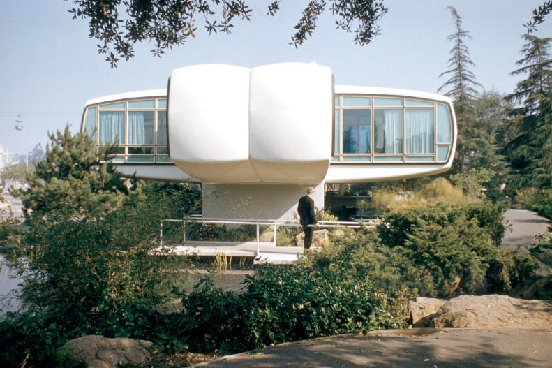 Raised Home With Floor to Ceiling Windows and Curved Walls