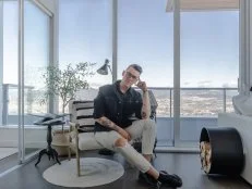 Man Sitting in Chair With Circle Area Rug Underneath