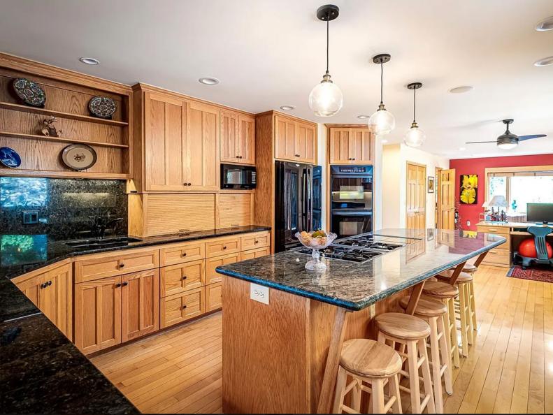 Prior to the renovation, this kitchen, while spacious with lots of storage, had nothing but wood tones as far as the eye could see.