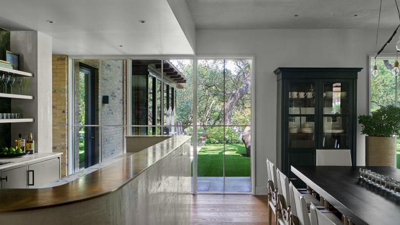 Bar Runs Parallel to Long Table in Dining Room