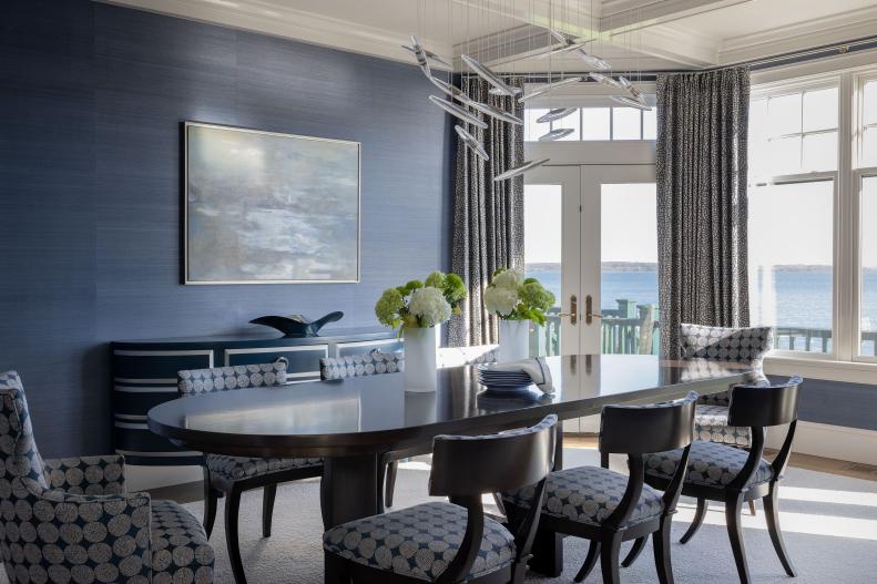 Formal dining room with eight-person table and dark blue wallpaper 