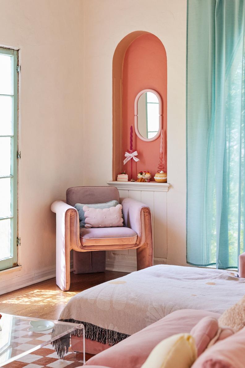 Pastel living room with pink-painted alcove and mint curtains. 