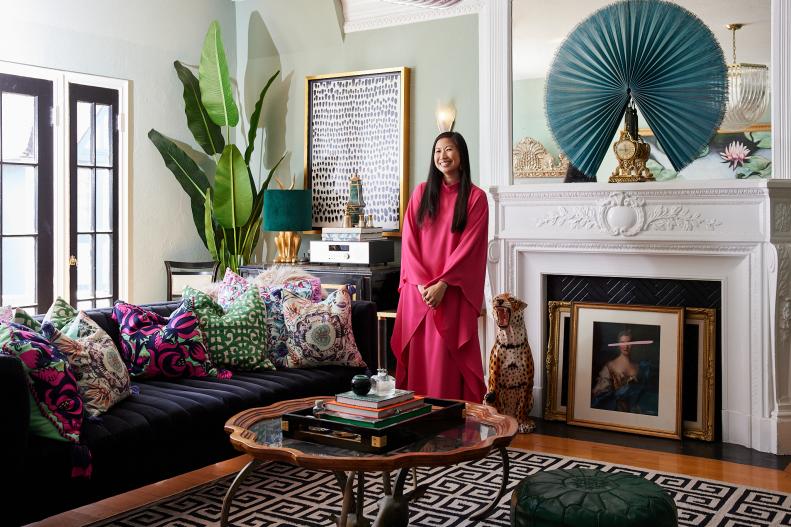 Woman in pink caftan in living room.