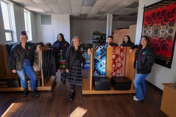 6 People Standing in Store With Matching Jackets