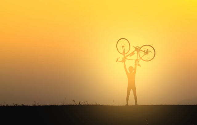 cyclist lifting bike