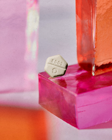 a pink cube with a white logo