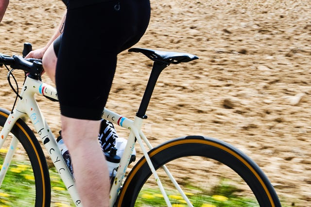 a person riding a bike out of the saddle