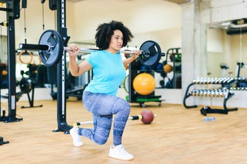 african woman practicing with barbells