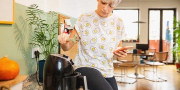 person cooking with air fryer