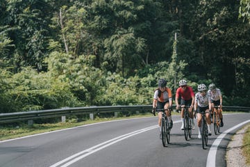 asian chinese female cyclist leading in rural cycling event