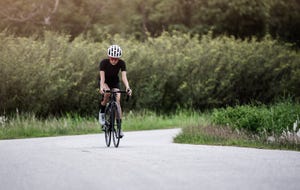 asian female cyclist cycling on track