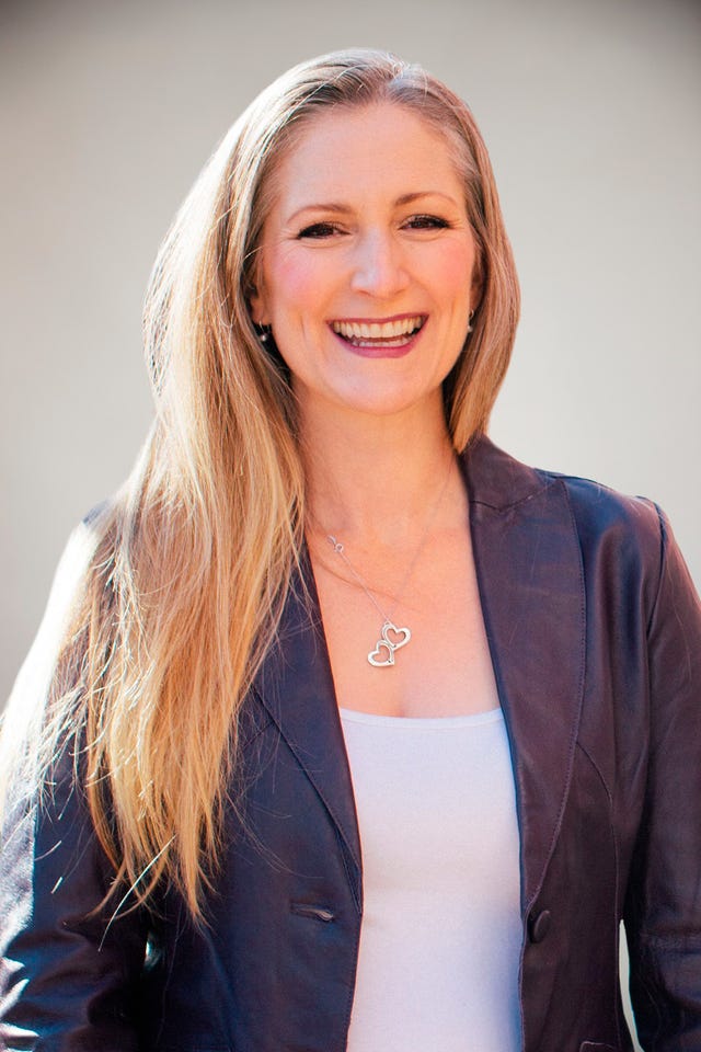 a woman with long hair smiling