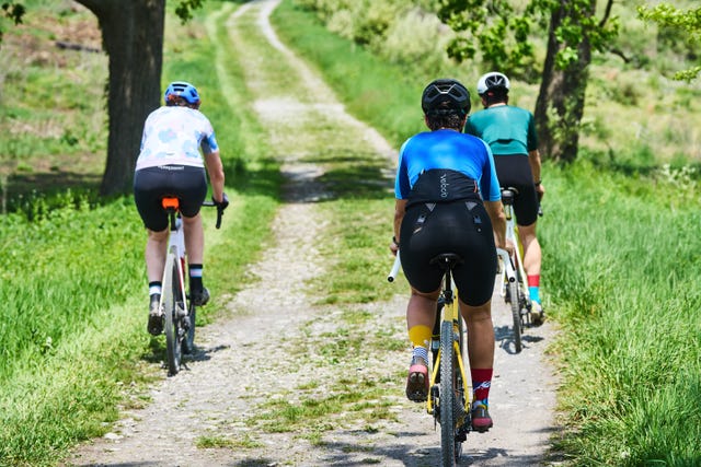 cyclists riding on a gravel road