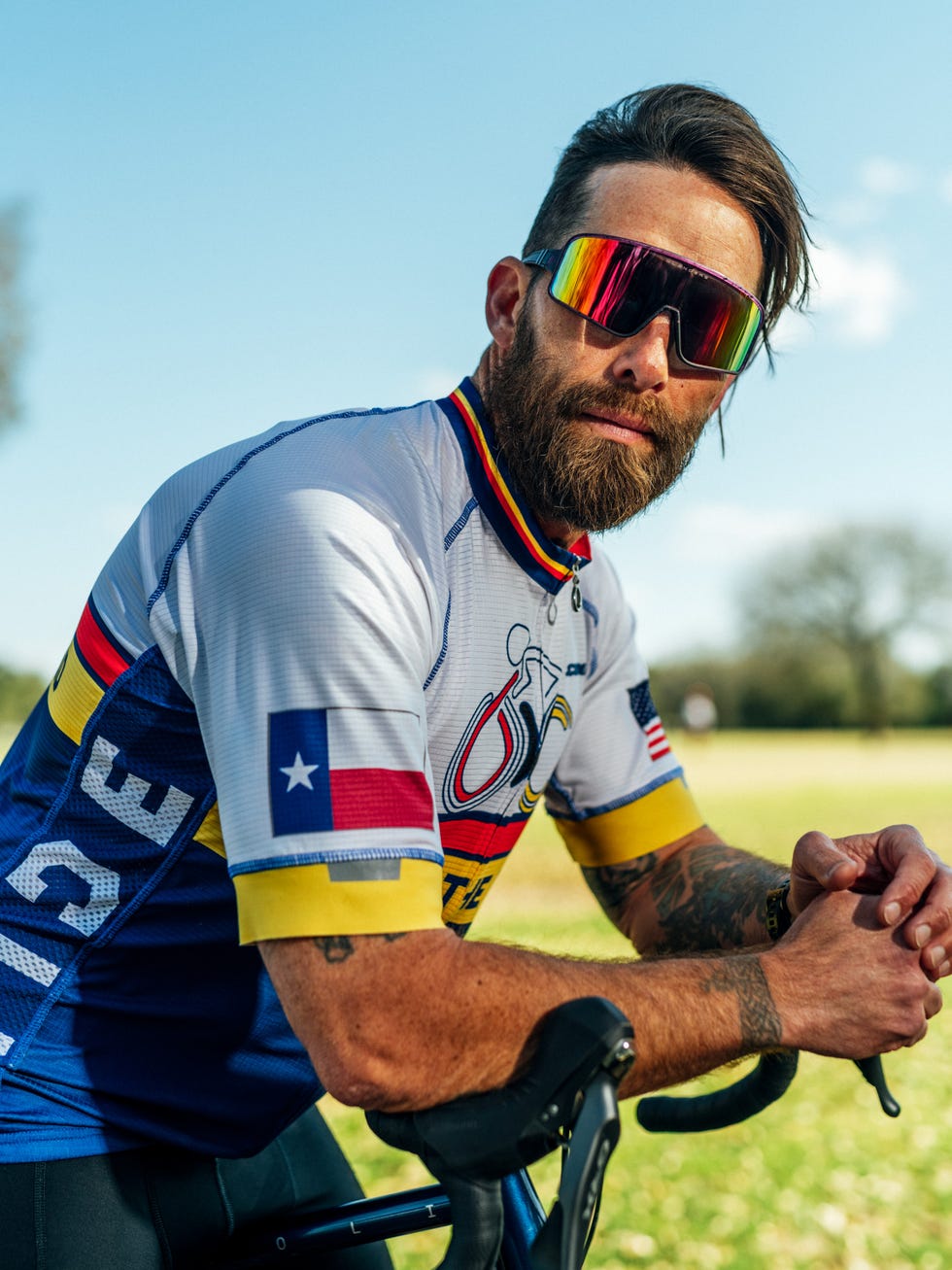 a cyclist poses for a portrait