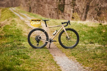 a bicycle parked on a dirt road