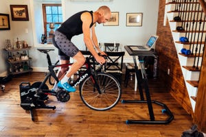 a cyclist riding an indoor trainer in a living room