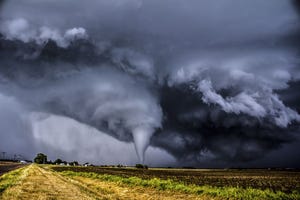 how tornadoes form, tornado seen in a field in the distance