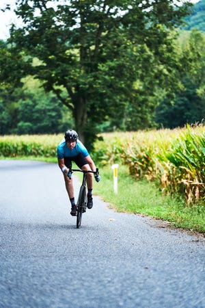 a woman riding a bicycle on a road