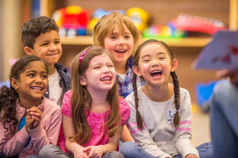 group of kids at school laughing at a teacher