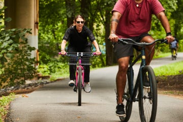 two cyclists on commuter bikes on a bike path