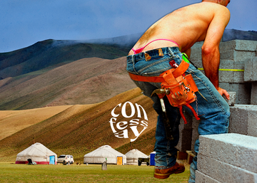 a shirtless man moving cinderblocks