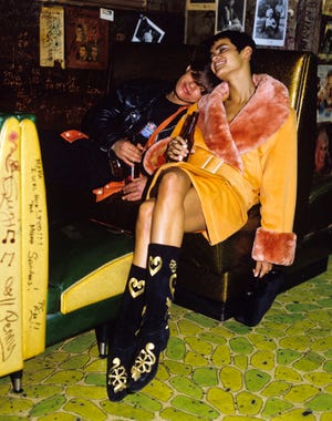 couple cuddling together in a booth