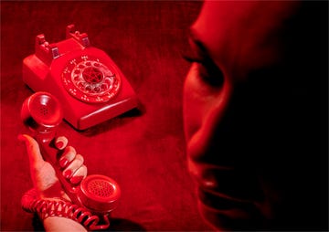 a person holding a red device