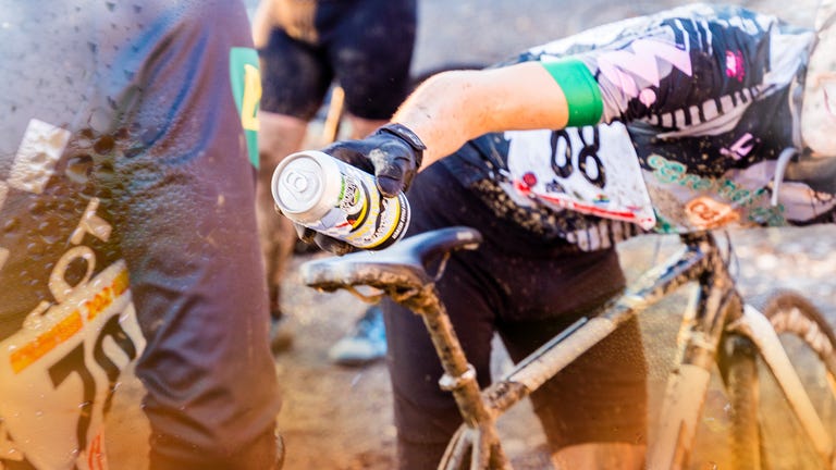 cyclist handing off beer at cyclocross event