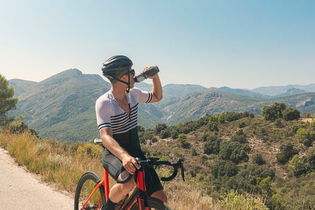 cyclist drinking from water bottle