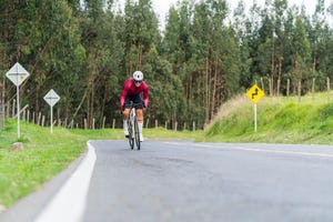 cyclist man is on the roads outside of bogota driving his bicycle