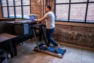 a man using an under desk treadmill